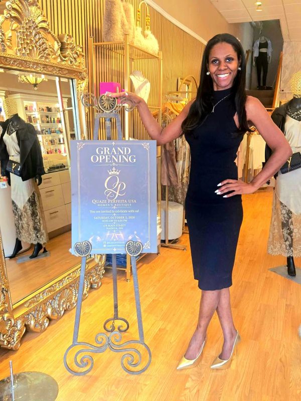 Woman celebrating grand opening at a boutique.