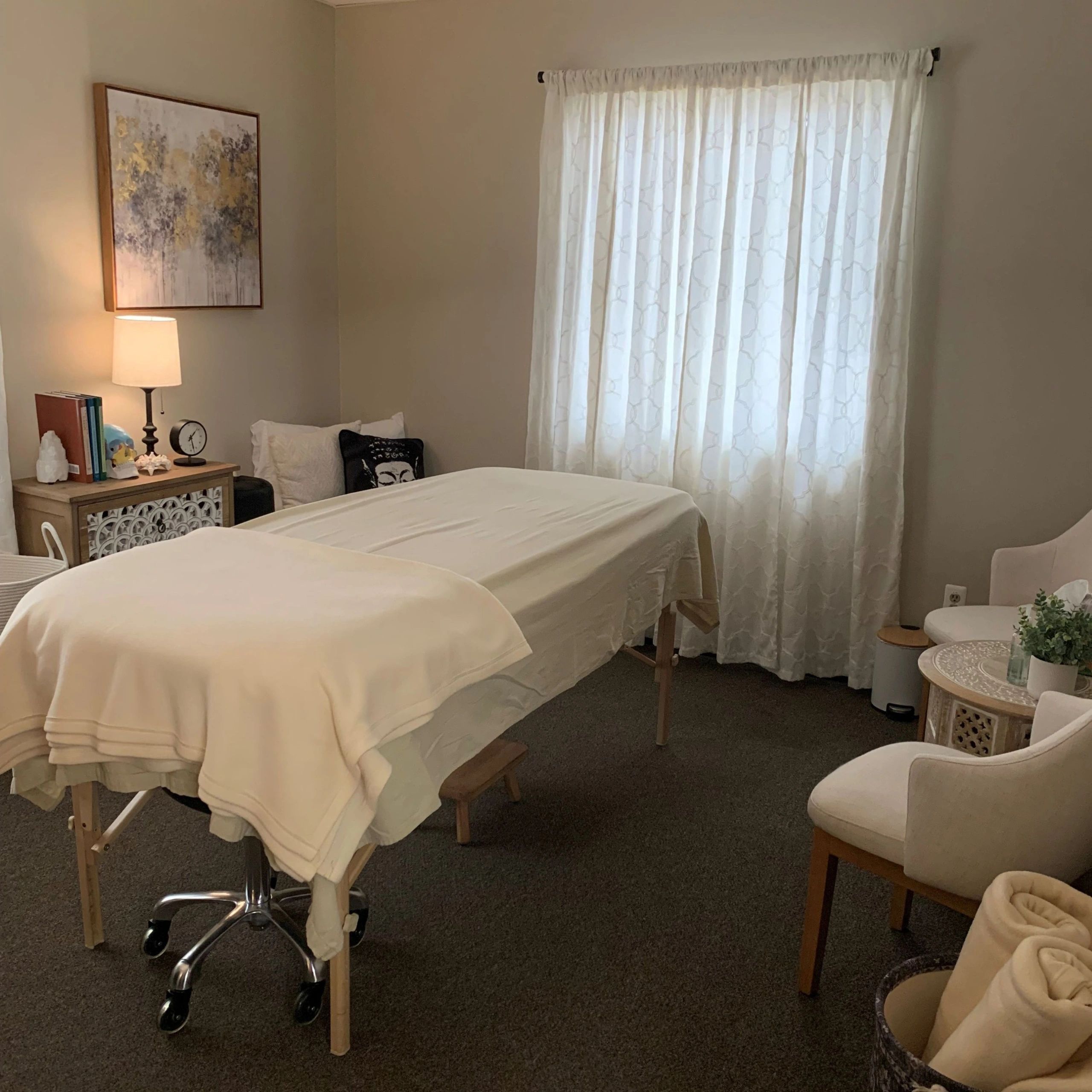 A treatment room with a massage table and a warm, calming vibe.