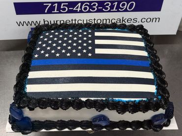 Square cake featuring a black and white American flag with a blue stripe.