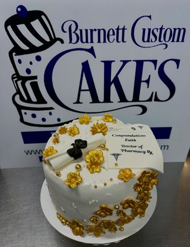 Elegant white and gold cake celebrating a Doctor of Pharmacy achievement.