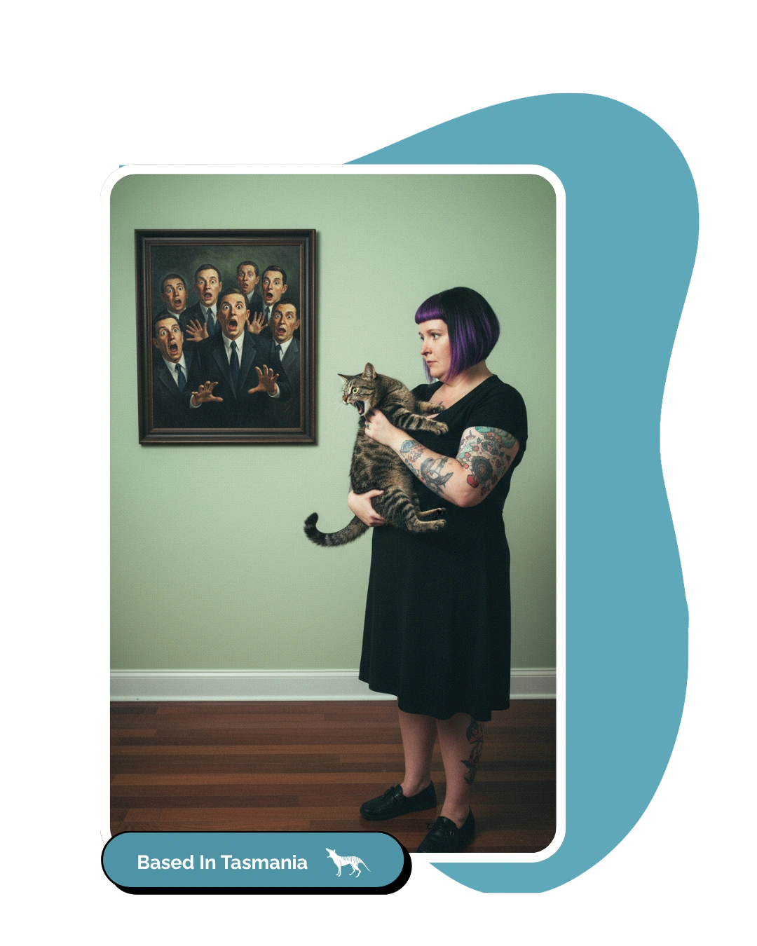 Woman holding a surprised cat with a shocked portrait on the wall.