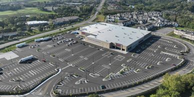 A large shopping center with a mostly empty parking lot.