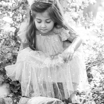 Child sitting in the woods.