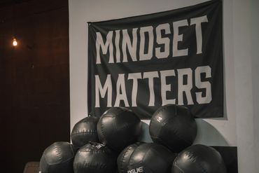 A motivational banner saying "MINDSET MATTERS" above exercise balls in a gym.