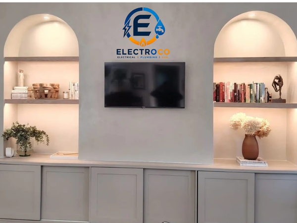 Modern living room shelving with TV and decorative items.
