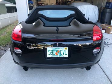 Rear view of black Pontiac Solstice convertible.