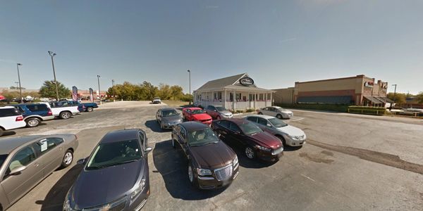 Used car lot with office building on I-35E in Lancaster, TX.