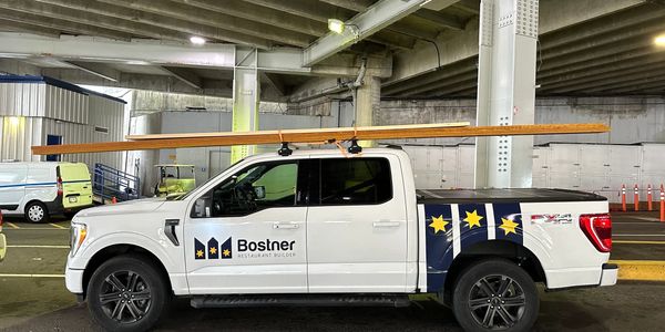 Image of a white Ford truck featuring Bostner Restaurant Builder branding