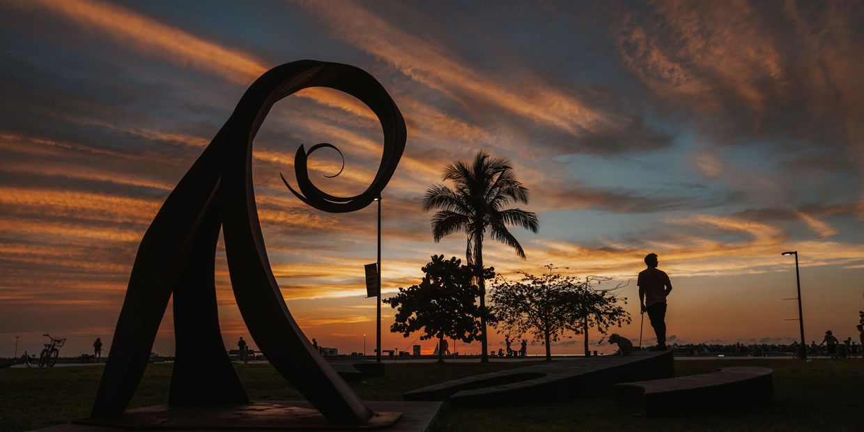 Sunset in Key West Truman Waterfront park with boy and his dog. 