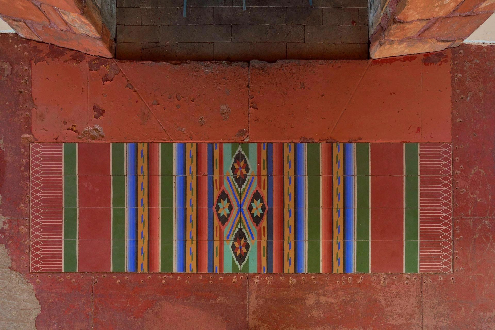 Hand-painted Native American tile rug at the hearth