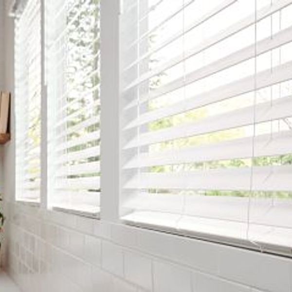Three windows with wood slat blinds.