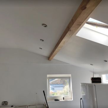 Freshly painted kitchen wall and ceiling with skylight.
 