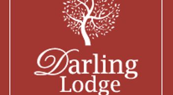 Logo of Darling Lodge Guest House with a stylized tree on red background.