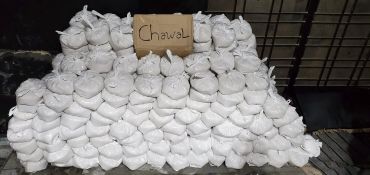 Stacks of white rice bags labeled 'Chawal'.