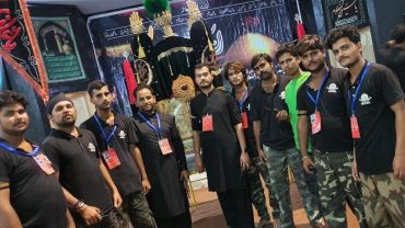 Group of men posing indoors with religious decorations.
