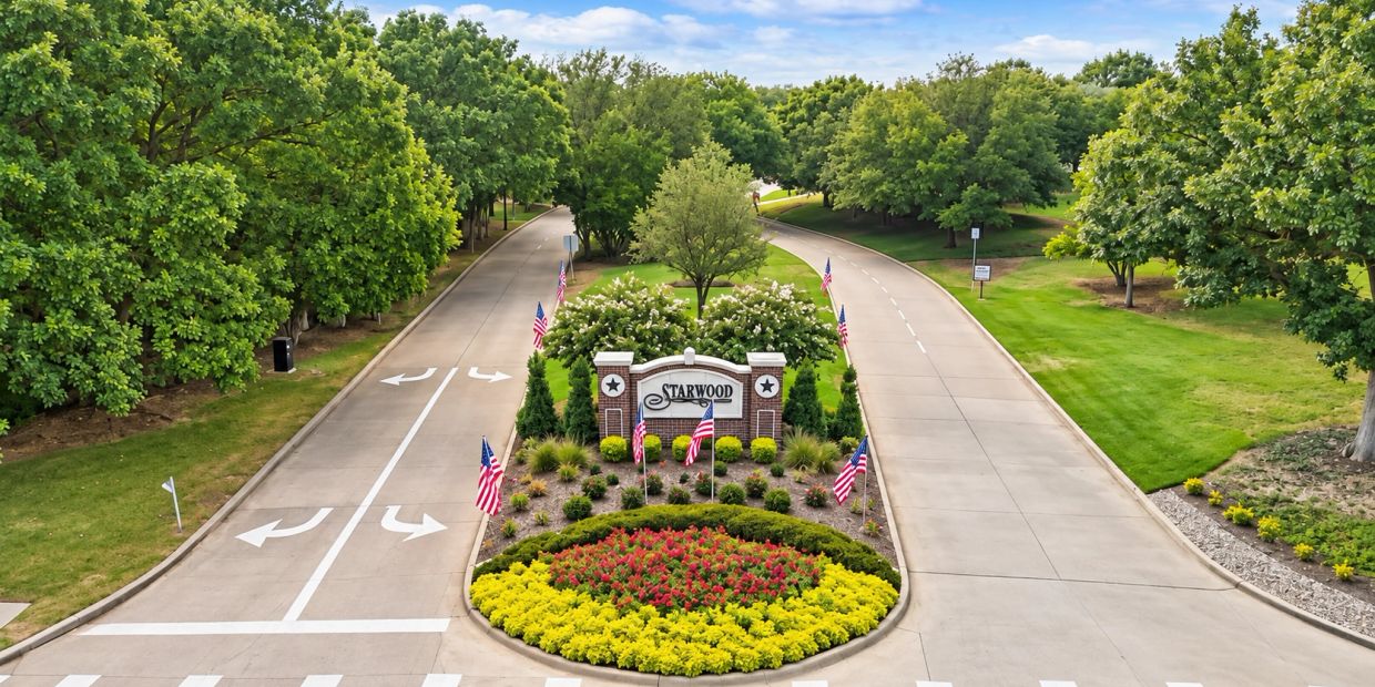 Entrance to Starwood with landscaped island and American flags.