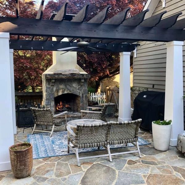 outdoor fireplace with gazebo and stone