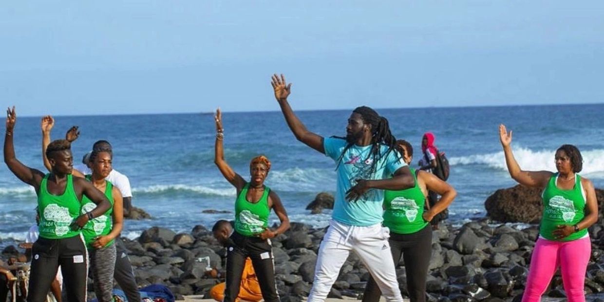 Group of people dancing on the beach.