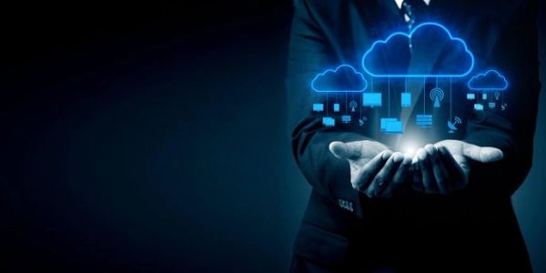 Person holding a glowing digital cloud computing icon.