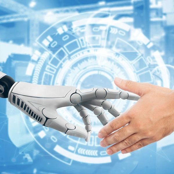 A robotic hand and a human hand reaching to touch each other.