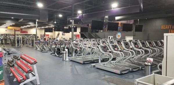 Empty gym with treadmills and weights.