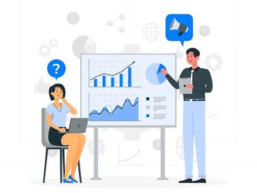 Two people discussing charts during a presentation.