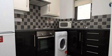 Student kitchen in Canterbury at a one bedroom flat with washing machine, cooker and fridge/freezer