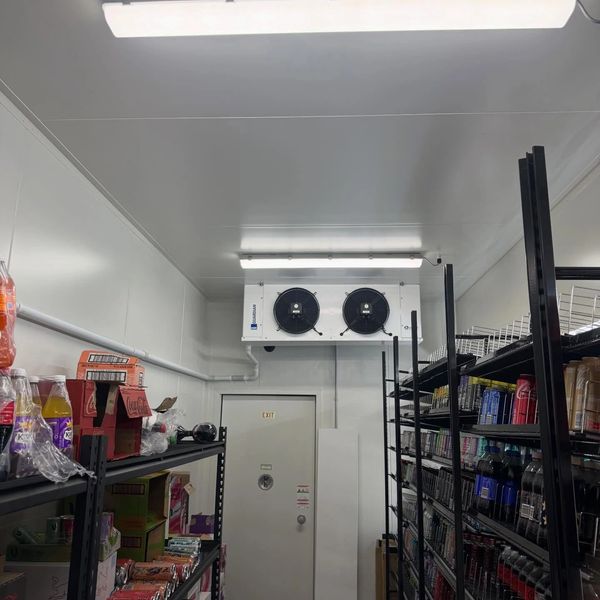Storage room with shelves stocked with beverages and snacks.