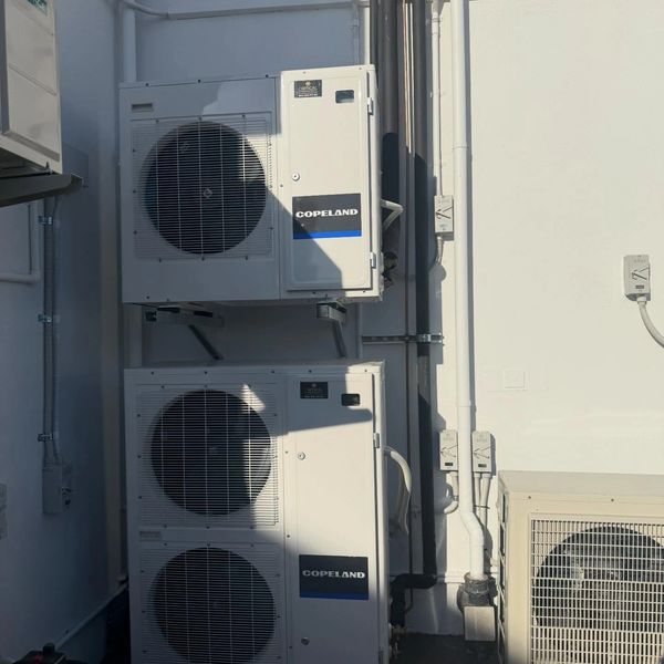 Two stacked Copeland air conditioning units on a building exterior.