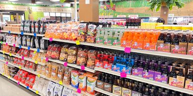 Grocery aisle at Dayly’s Farm Market featuring pantry staples, bulk rice, international foods, and e