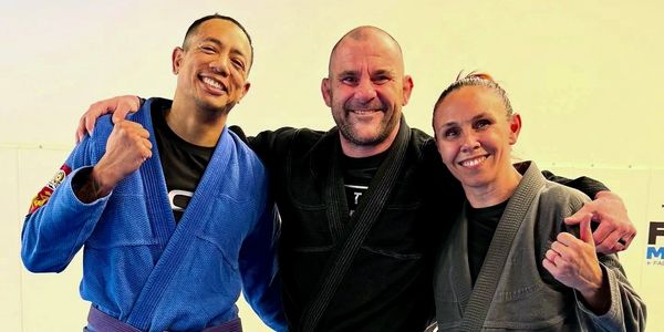 Professor and two students after they were promoted with stripes training in Brazilian hit jitsu