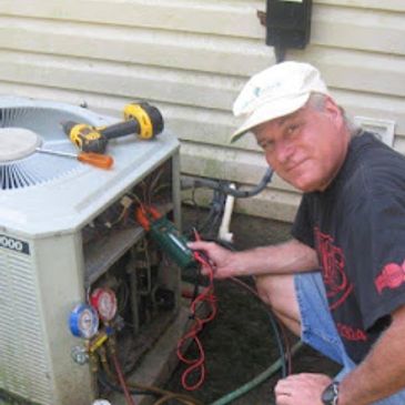 Technician repairing an outdoor air conditioning unit with tools.