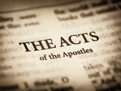 Close-up of "The Acts of the Apostles" text in a Bible.
