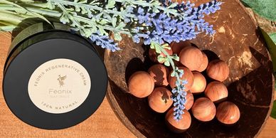 Natural skincare cream with hazelnuts and lavender on wooden surface.