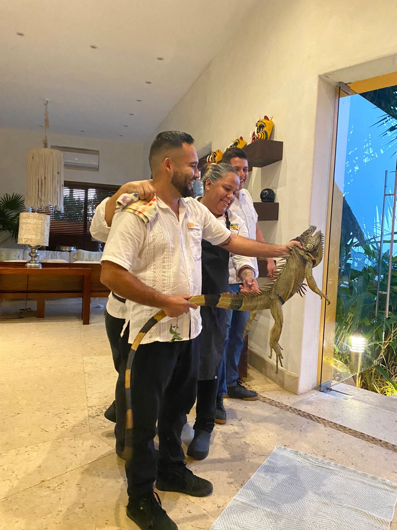 Villa staff with a friendly iguana visitor