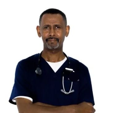 Confident male doctor in navy scrubs with stethoscope.