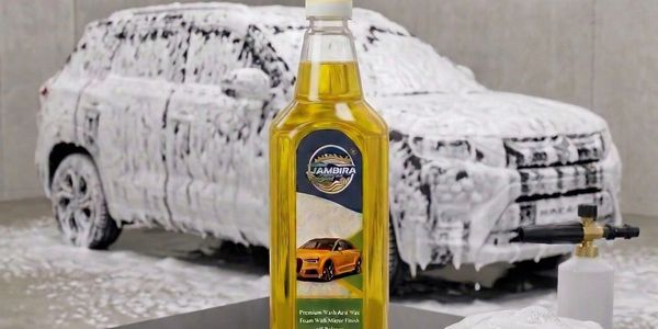 A soapy car wash with a bottle of car wax in the foreground.