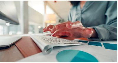 Professional transcriptionist working at a computer.