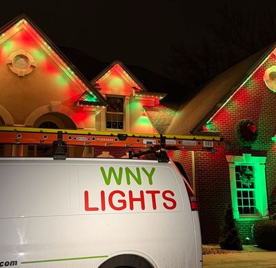 A scenic landscape with mountains, a lake, and trees under a clear blue sky.