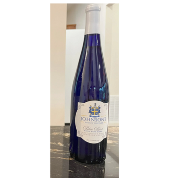 A blue bottle of Johnson's Legacy Vineyard Blue Bird white wine blend.