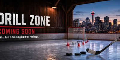 Hockey drill zone with puck and stick, city skyline in background.