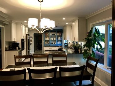 Renovated kitchen with divider wall removed and custom bookcase added for a more open concept 