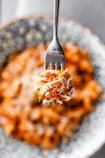 Spaghetti on fork with parmesan cheese