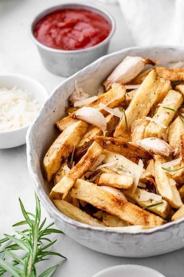 Tuscan fries with rosemary and garlic with a serving of ketchup 