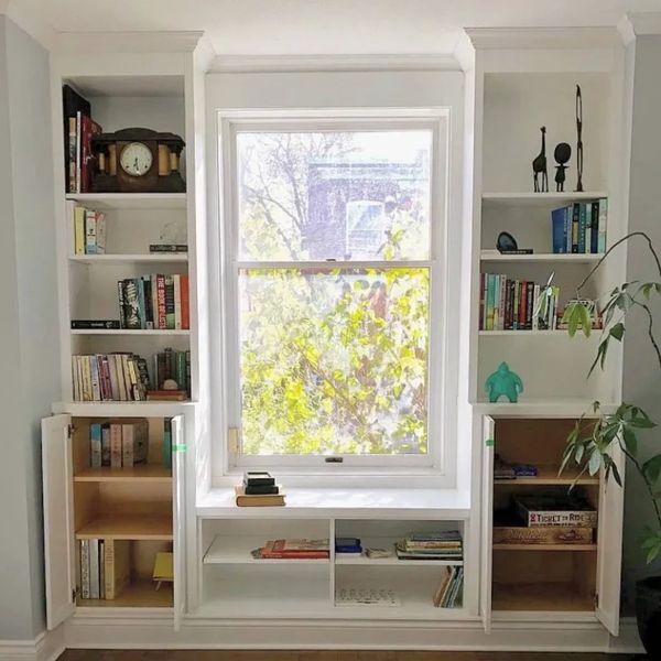 Window bench reading nook with built-in bookshelves and storage