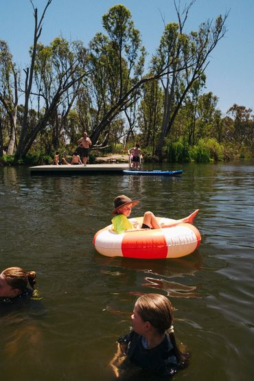 Guests enjoying water activities on the Loddon River at Bridgewater Caravan Park