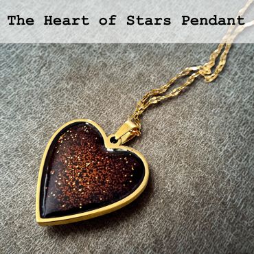 Heart-shaped pendant with glittery star-like design.