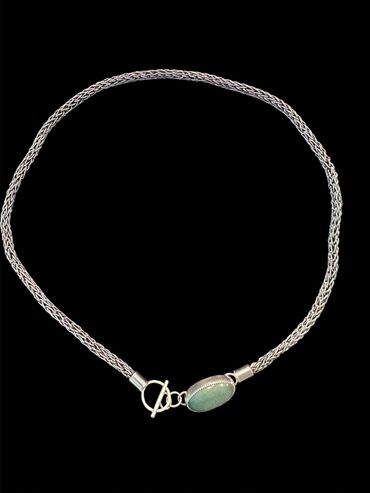 Silver necklace with a green oval pendant and toggle clasp.