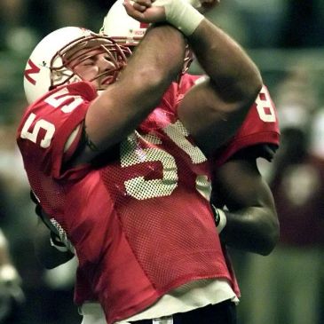 Two American football players celebrating during a game.
