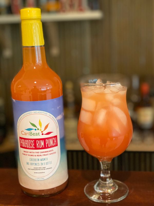 Bottle and glass of Paradise Rum Punch.